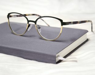 close up shot of a pair of eyeglasses on top of a notebook